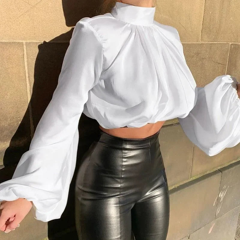 white high-neck blouse with puff sleeves, paired with black leather pants, chic daytime look