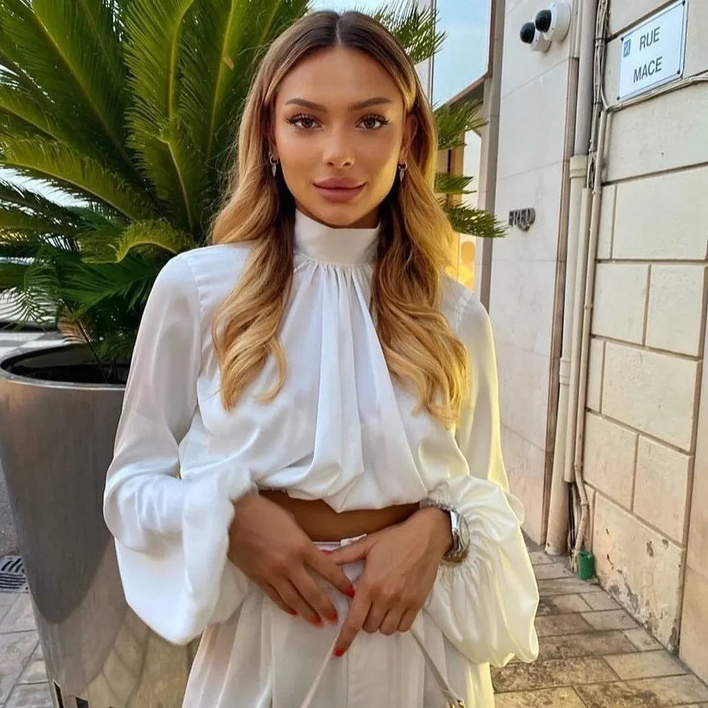 white long-sleeve top with high neck, elegant style