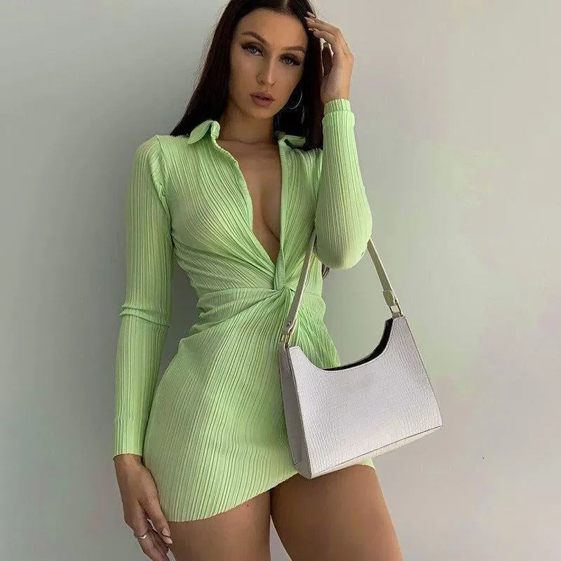 ribbed long-sleeve mini dress with plunge neckline, paired with a croc-embossed handbag, party