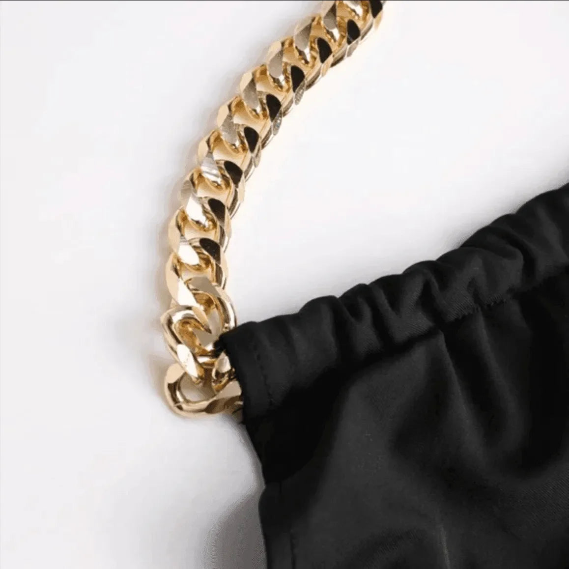 black bag with gold chain strap, evening accessory