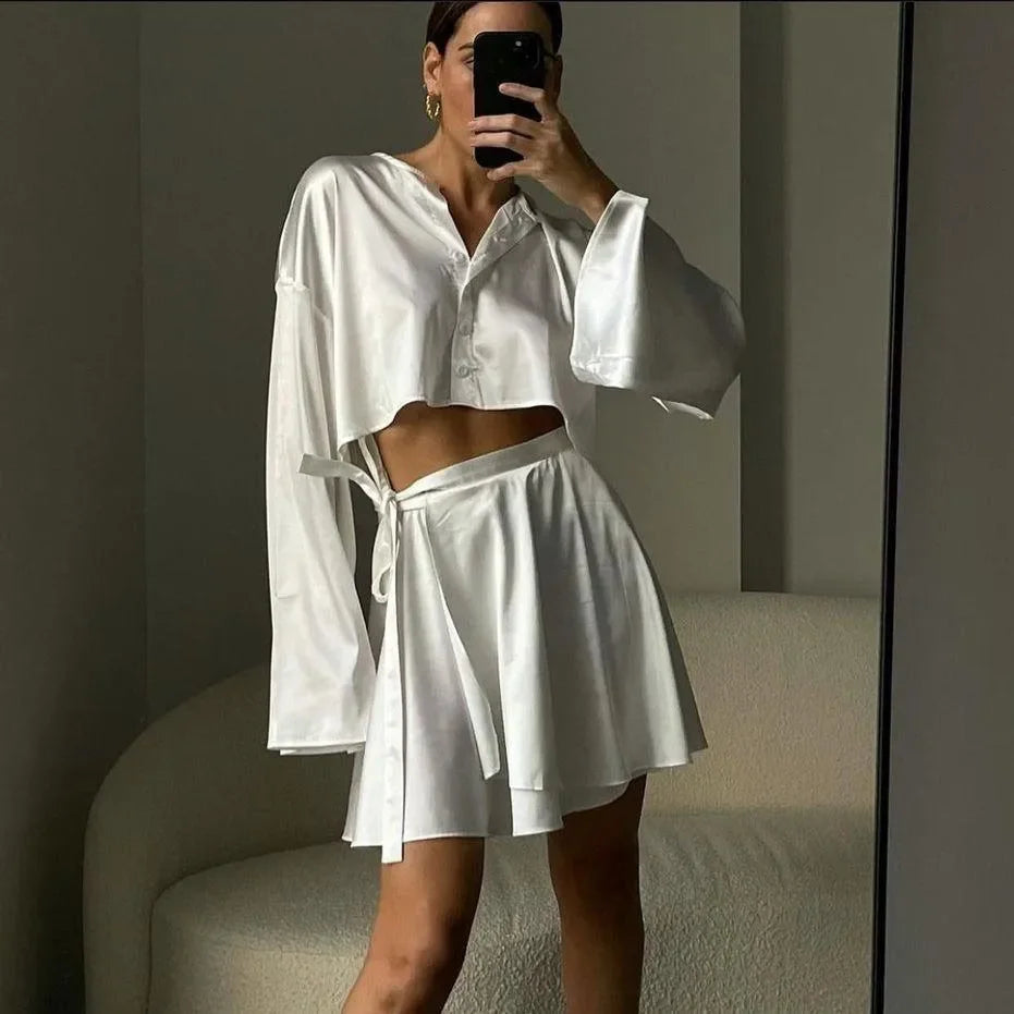 white satin co-ord set with long sleeve crop top and wrap skirt