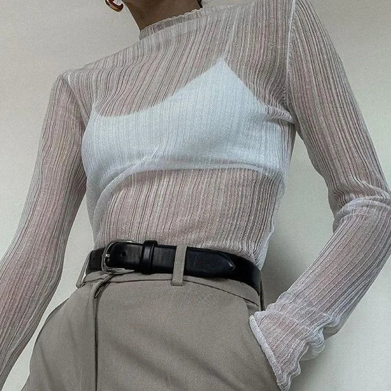 Sheer ribbed long-sleeve top with high neck and black belt.