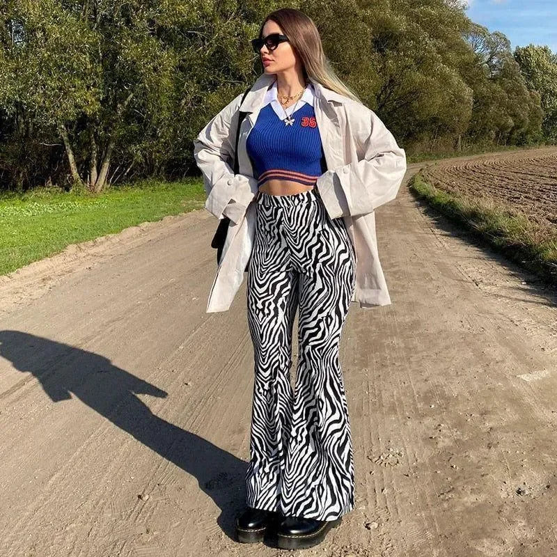 zebra-print flared pants and blue crop top, casual outdoor style
