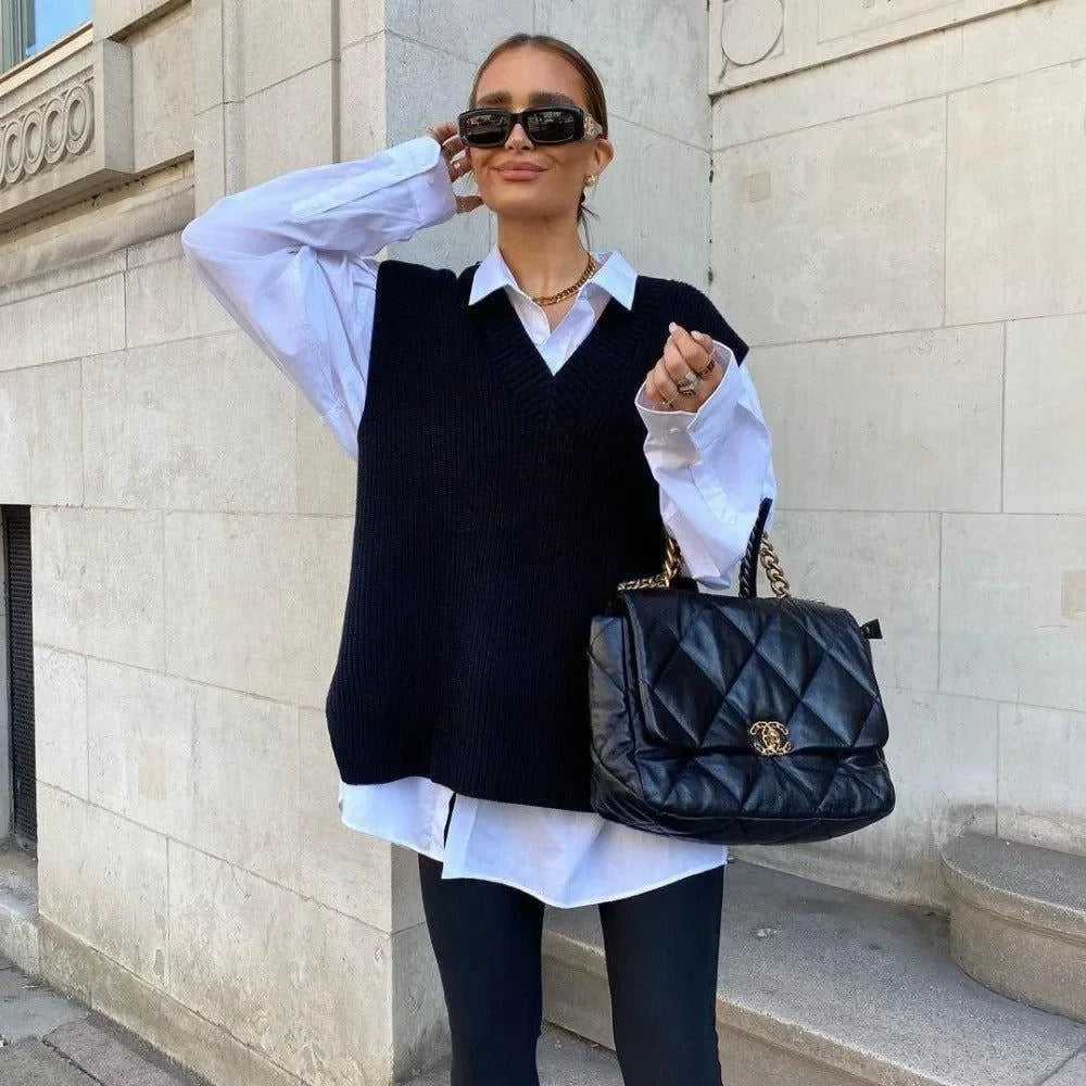 black knitted vest over white shirt, paired with quilted chain bag
