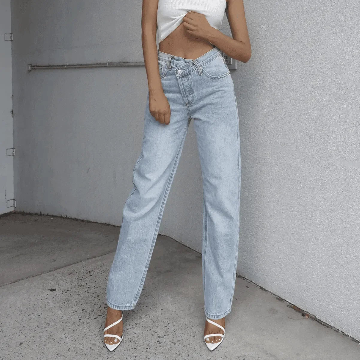 wide-leg light wash jeans with white strappy heels, casual style