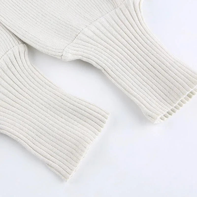 Cream ribbed knitted turtleneck crop sweater with flared sleeves, perfect for layering with high-waisted jeans.