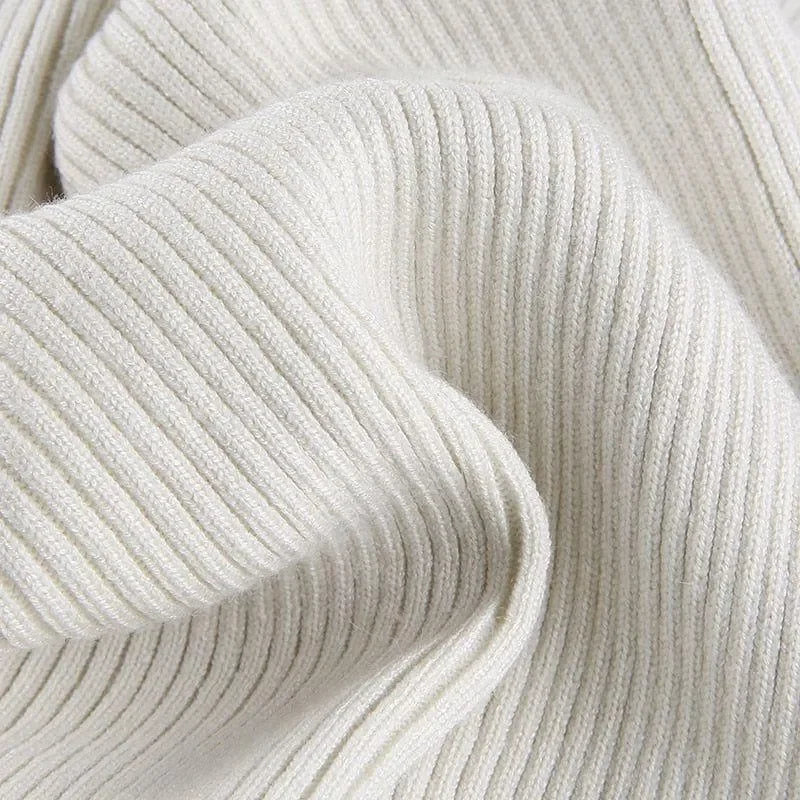 Cream ribbed knitted turtleneck crop top sweater, perfect for layering over high-waisted jeans or skirts.