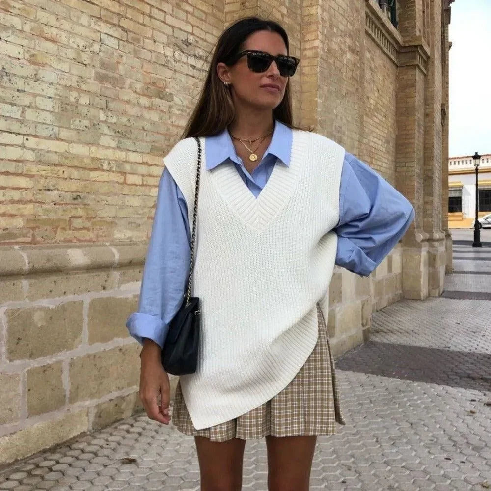 oversized knit vest layered over blue shirt, casual chic look