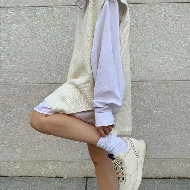 cream knit vest over white shirt with casual sneakers