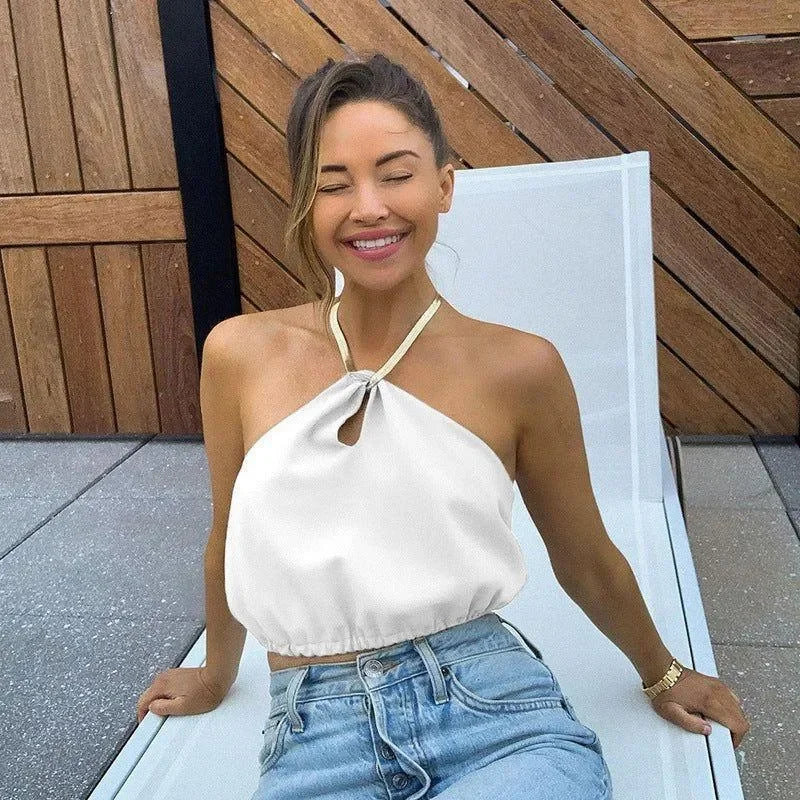 Halter neck top with keyhole detail and casual denim jeans.