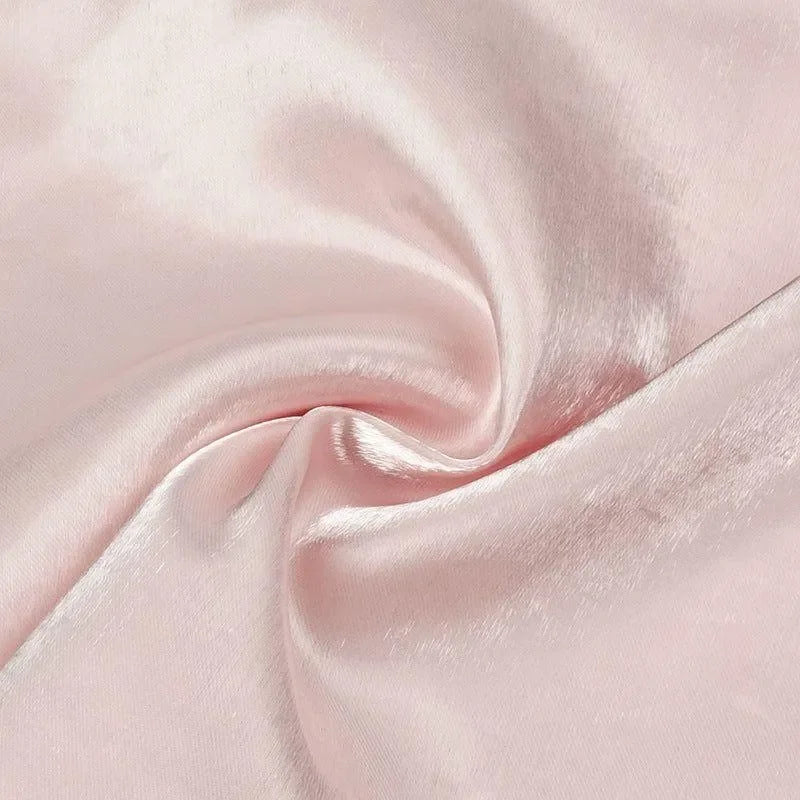 Soft pink satin fabric with a glossy texture.