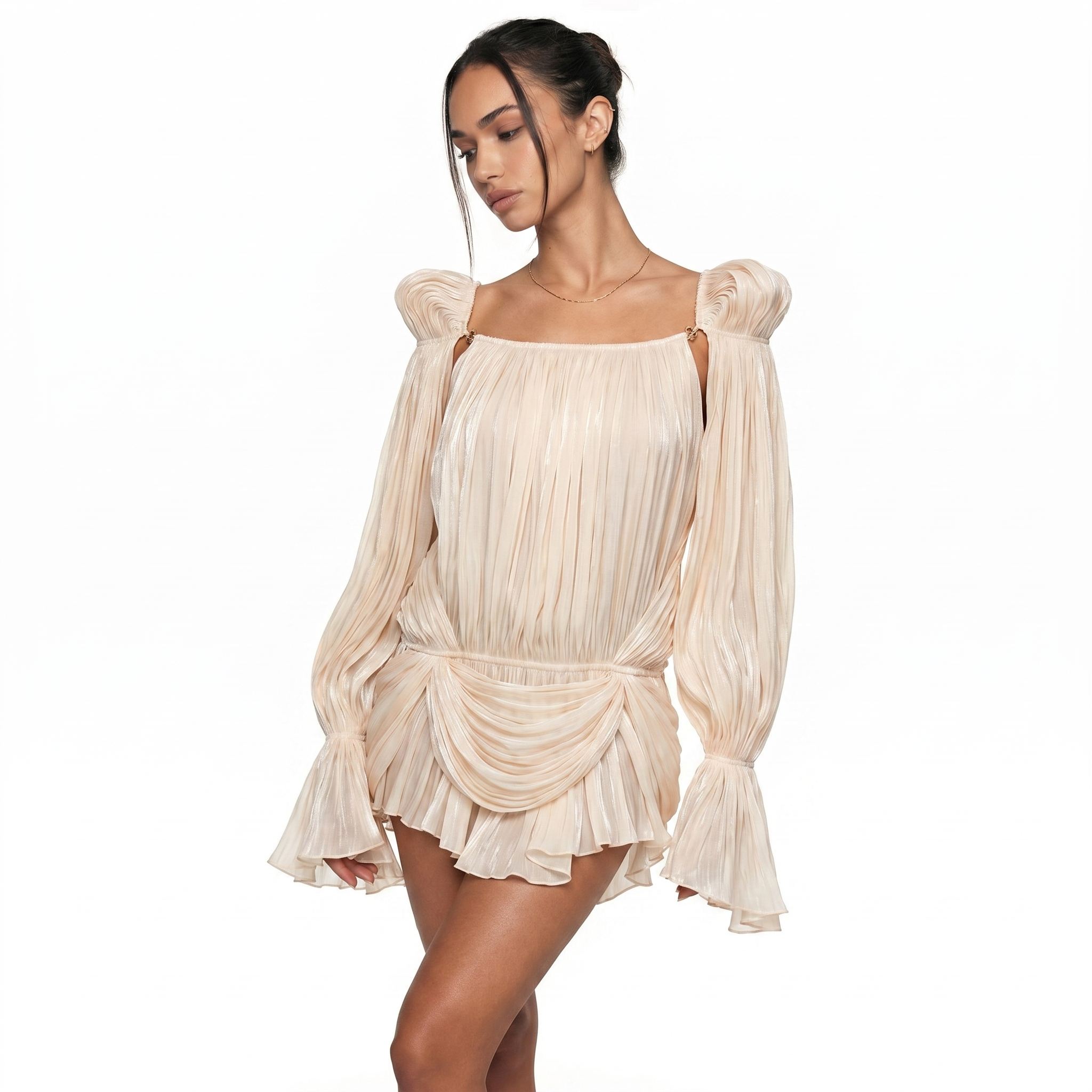Woman wearing a beige pleated dress on a white background
