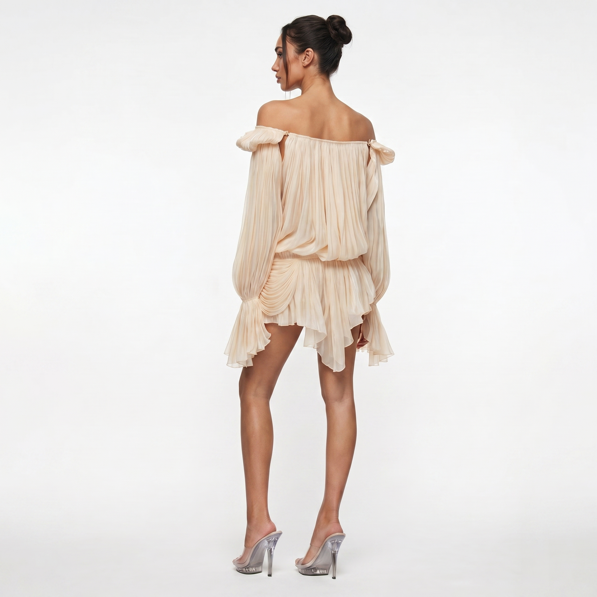 Woman wearing a beige off-shoulder dress on a white background