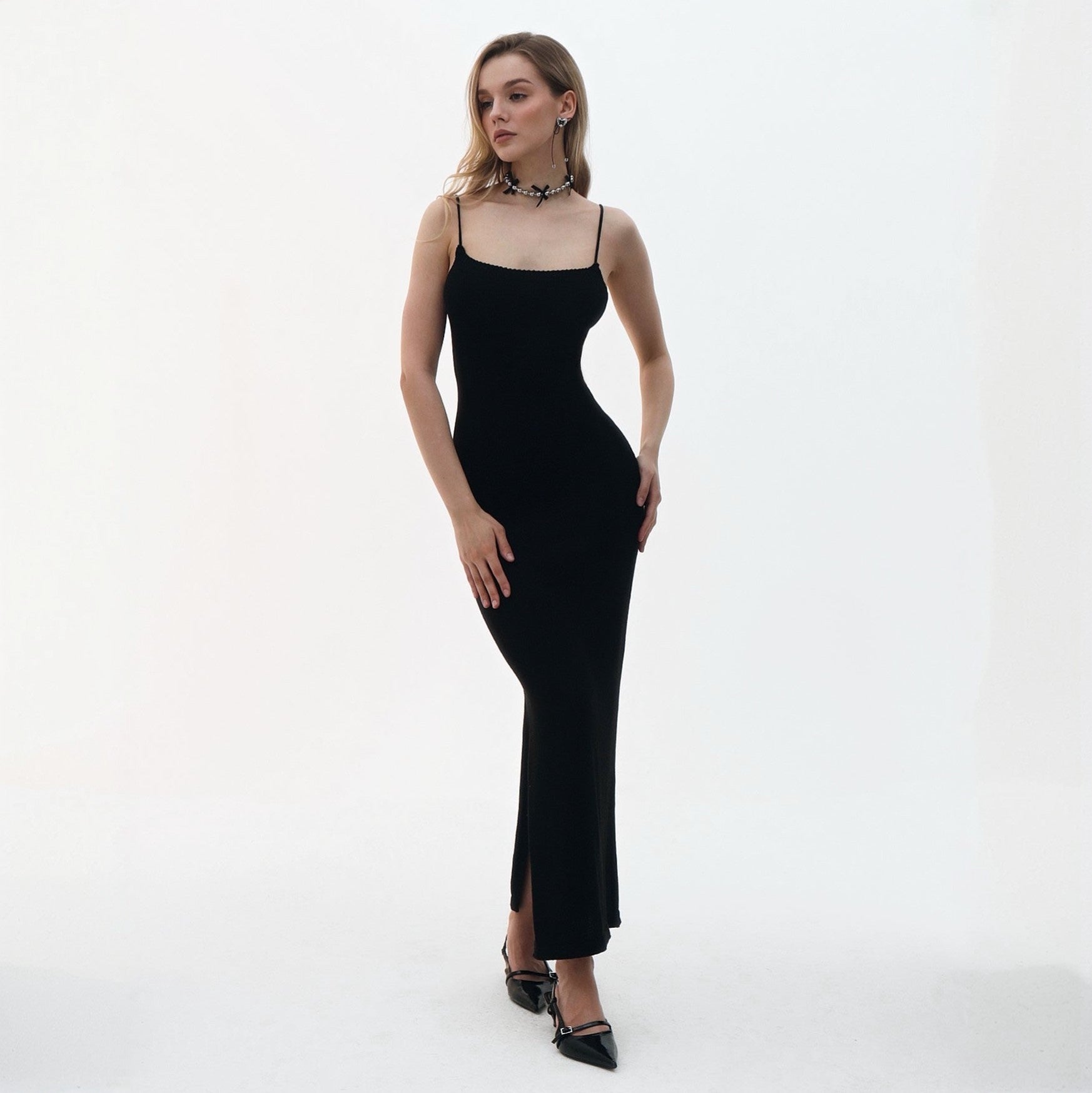 Woman wearing a black dress on a white background