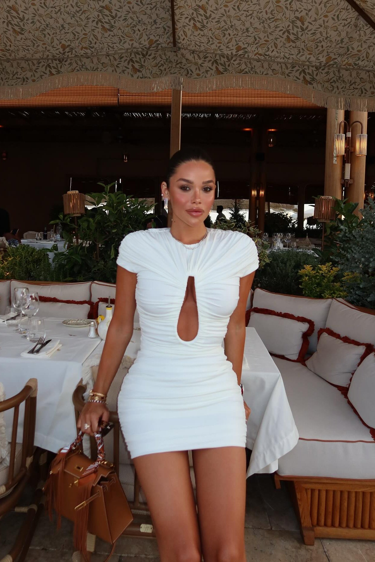 Close-up of ruching detail and keyhole cut-out on off-white mini dress