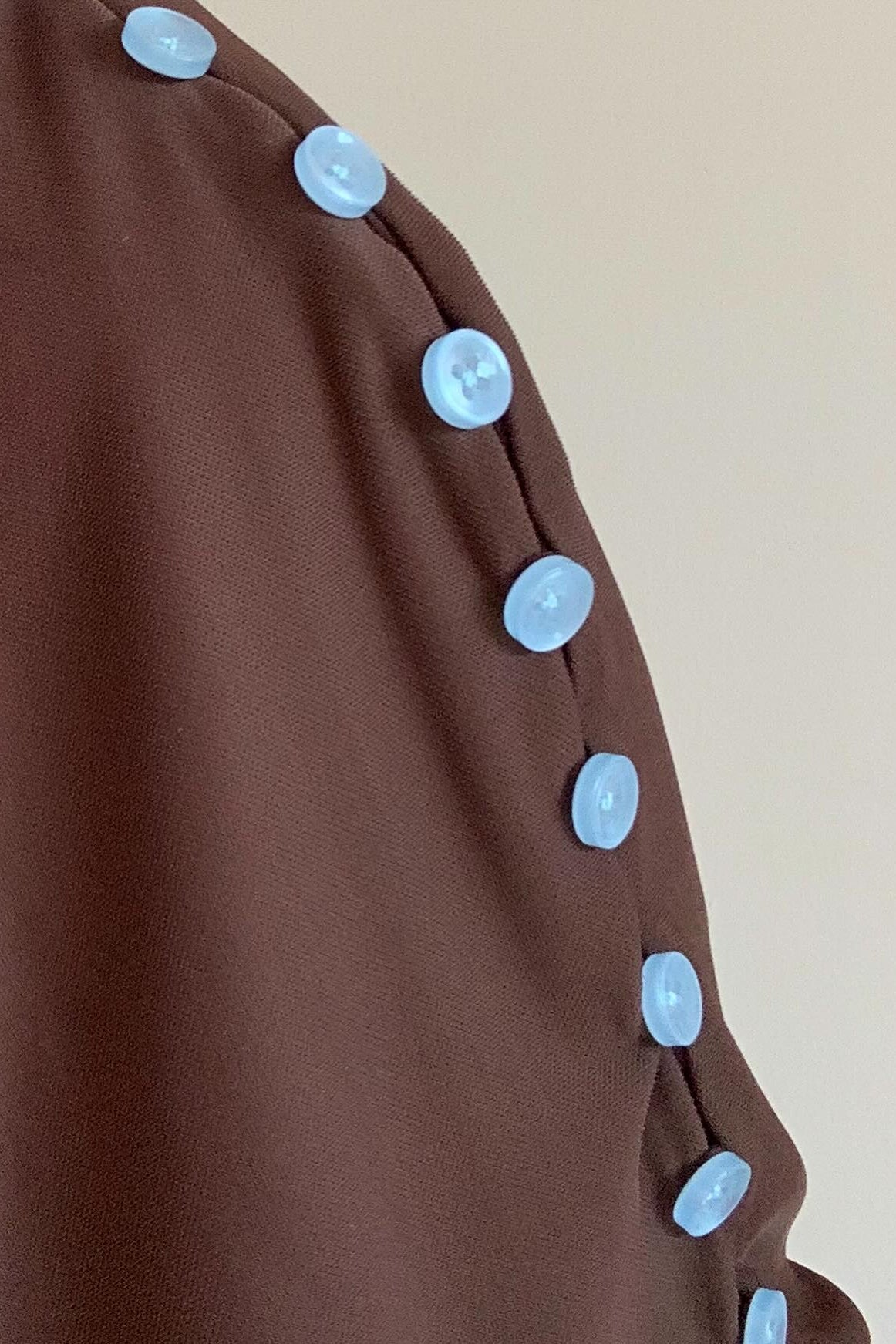Cai brown convertible top with button trim, close-up of draping detail