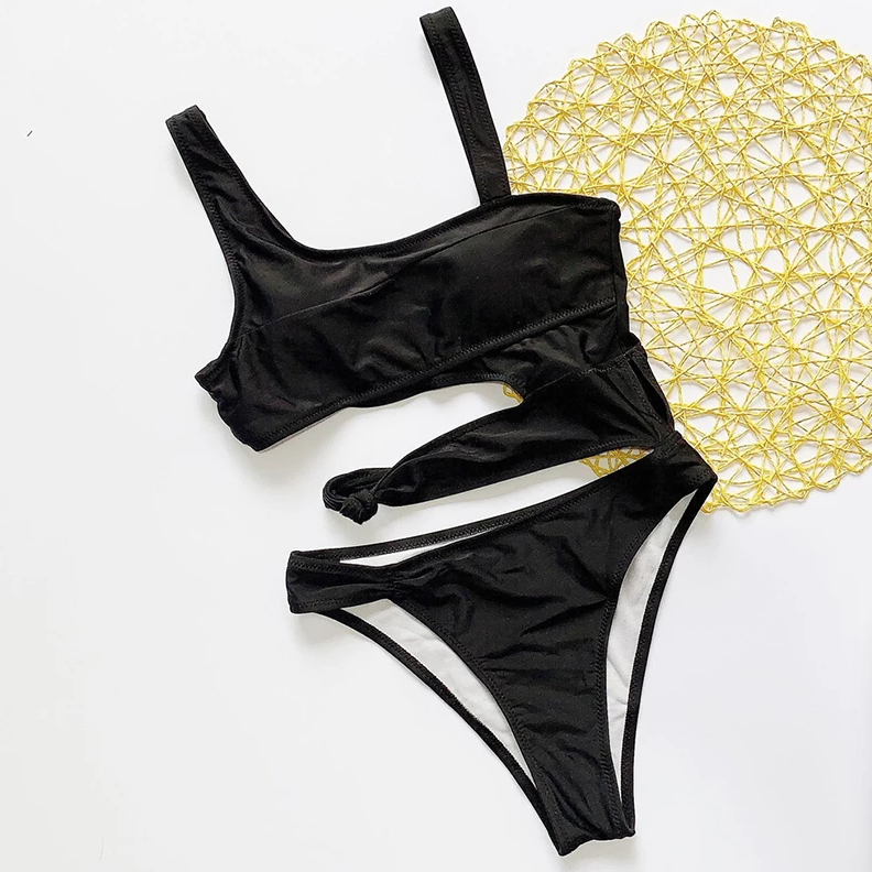 Black swimsuit with yellow decorative mat on a white background