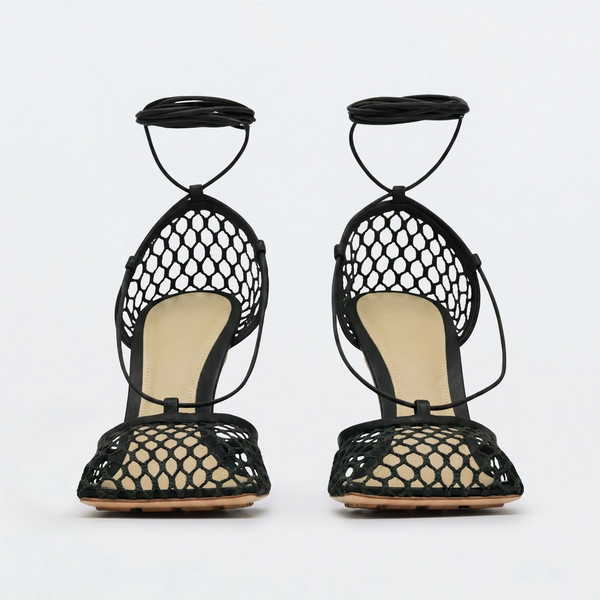 Black fishnet high-heeled sandals on a white background