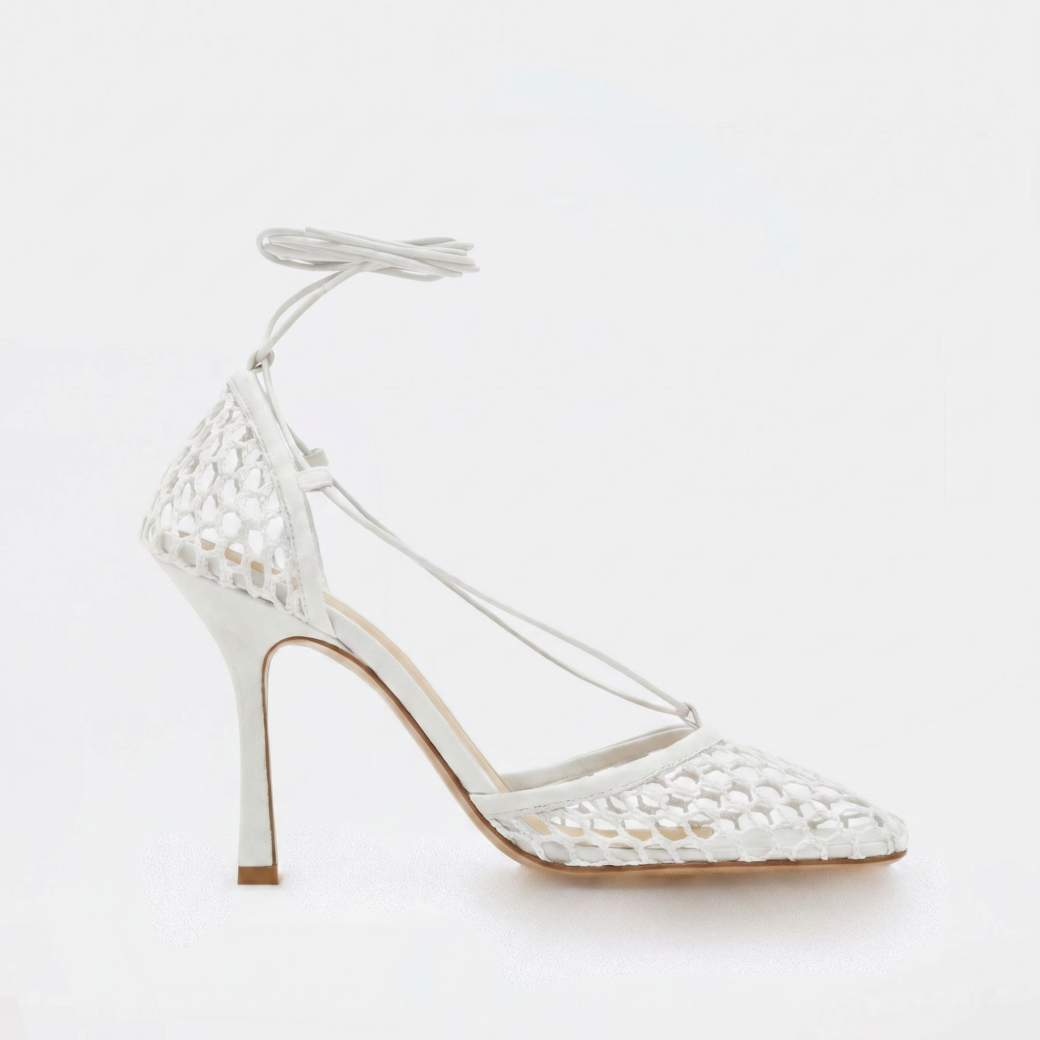 White high-heeled shoe with lace-up design on a light gray background