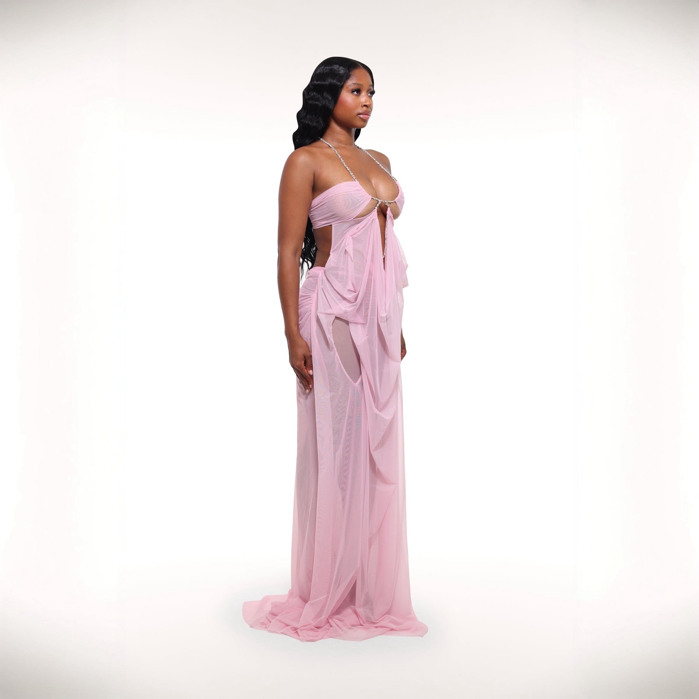Woman wearing a pink evening gown on a white background