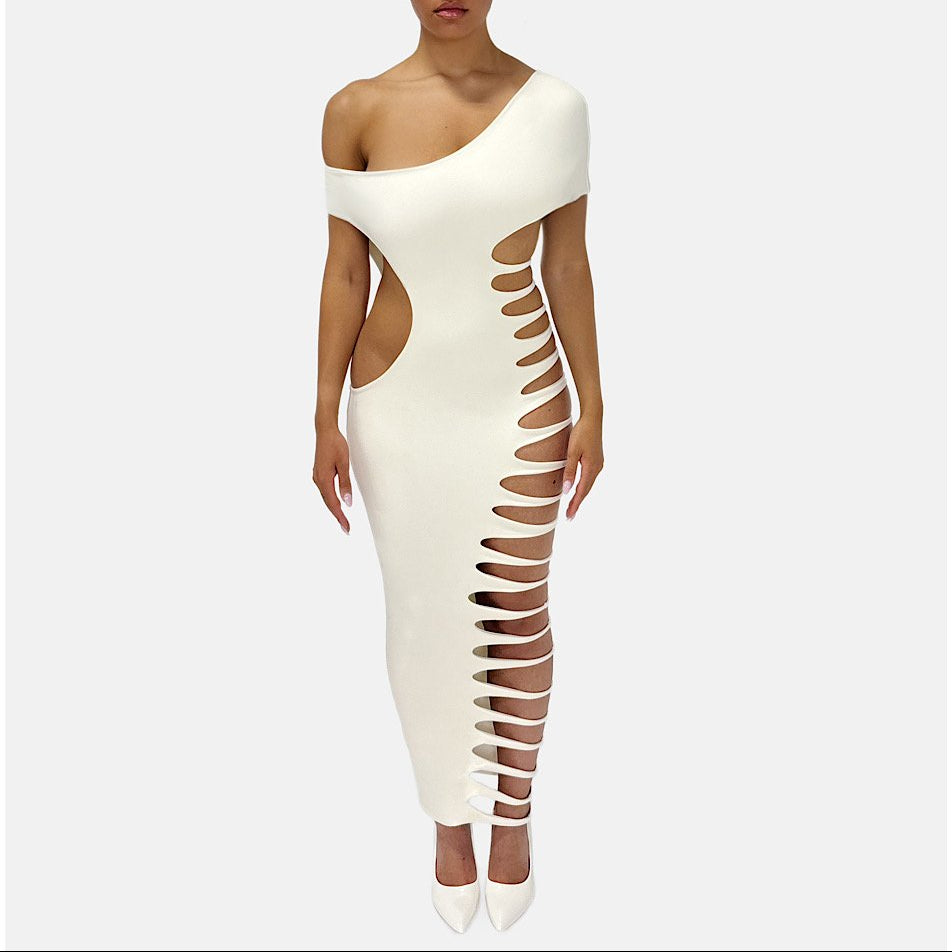 Woman wearing a white one-shoulder dress with cut-out design on a white background