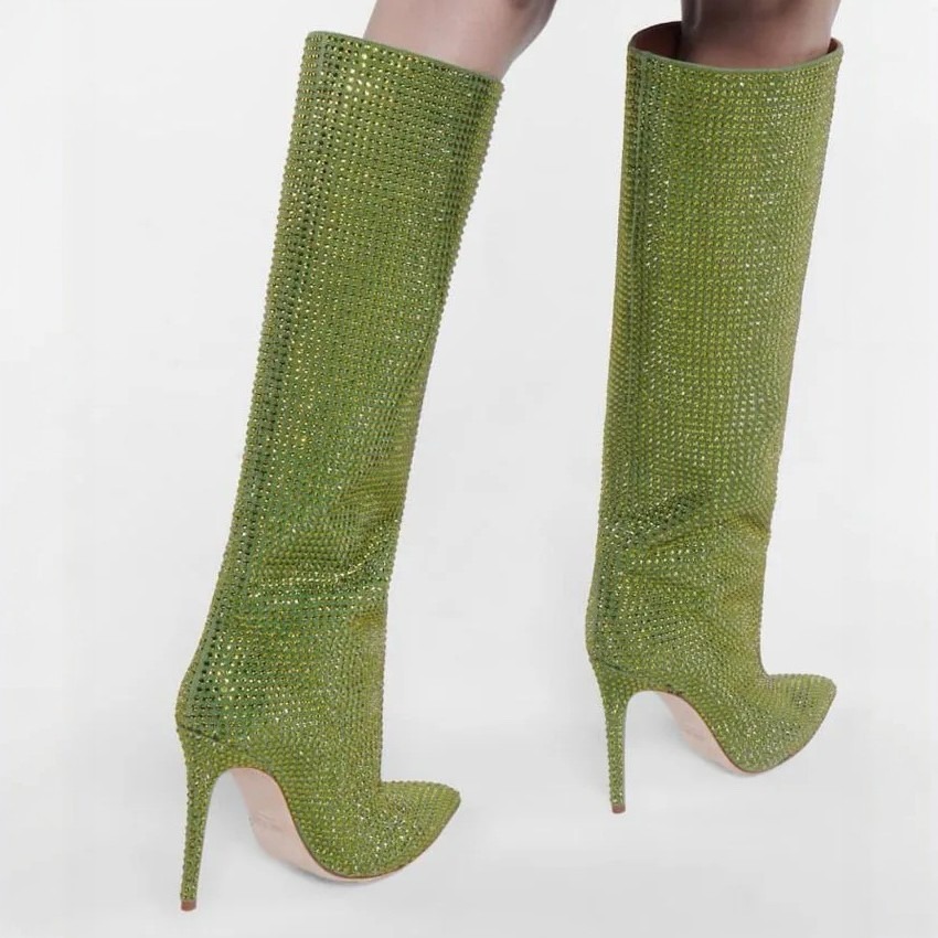 Green glittery knee-high boots on a white background