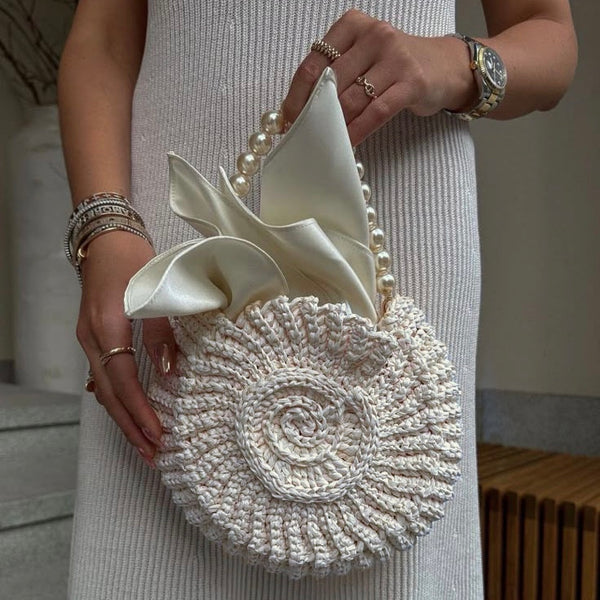 Woven circular handbag with pearl handle and satin detail