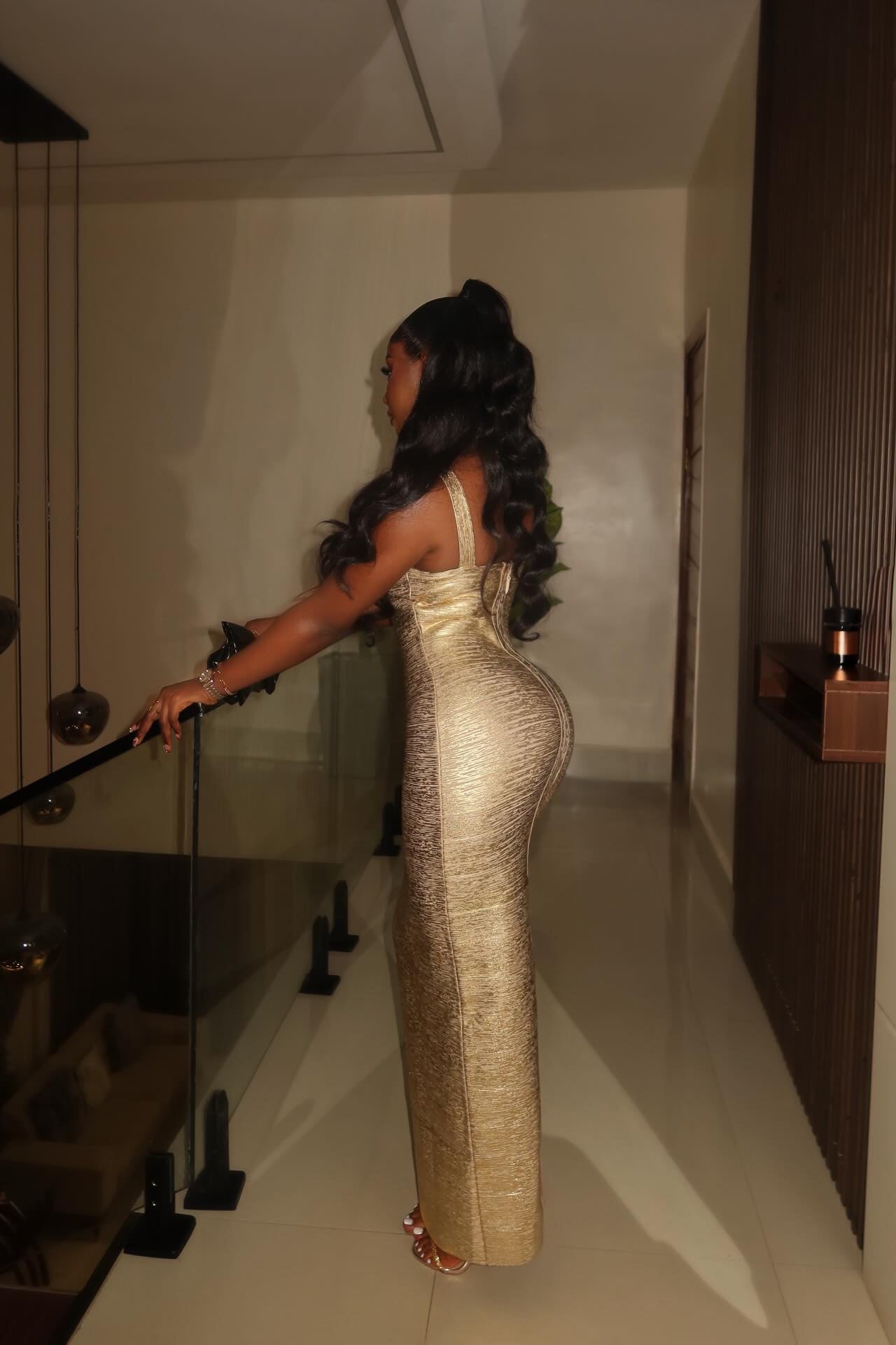 Model in gold metallic maxi dress with scoop neckline, evening look
