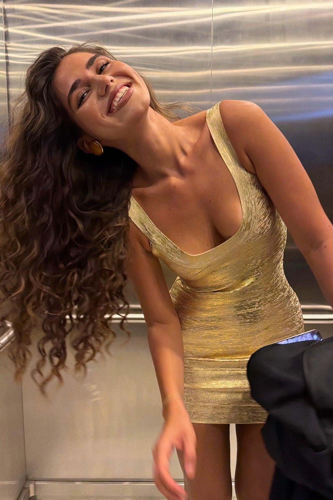 Gold metallic bandage mini dress with body-contouring fit, side profile