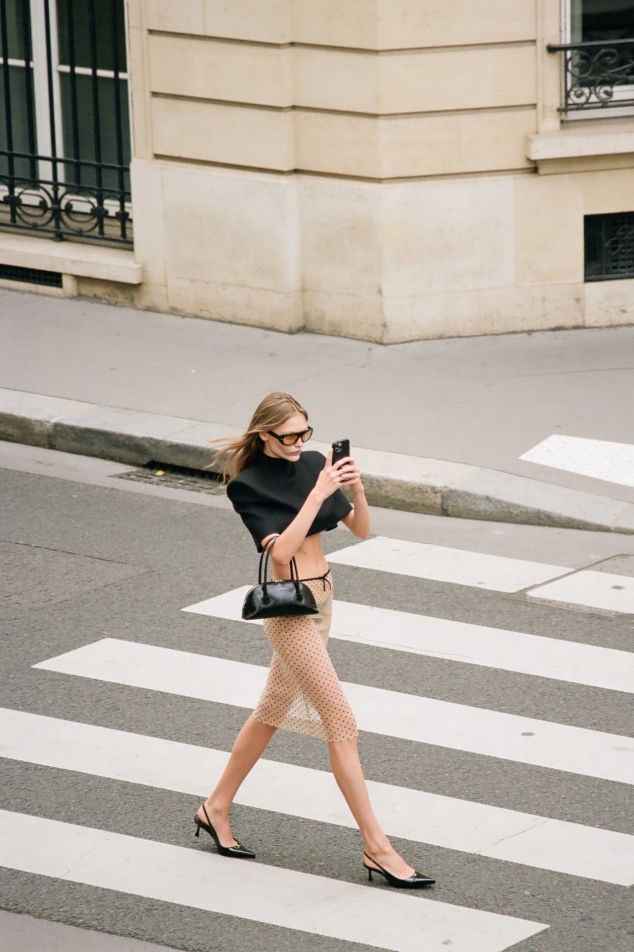 Beige polka dot mesh midi skirt, outdoor editorial fashion shot