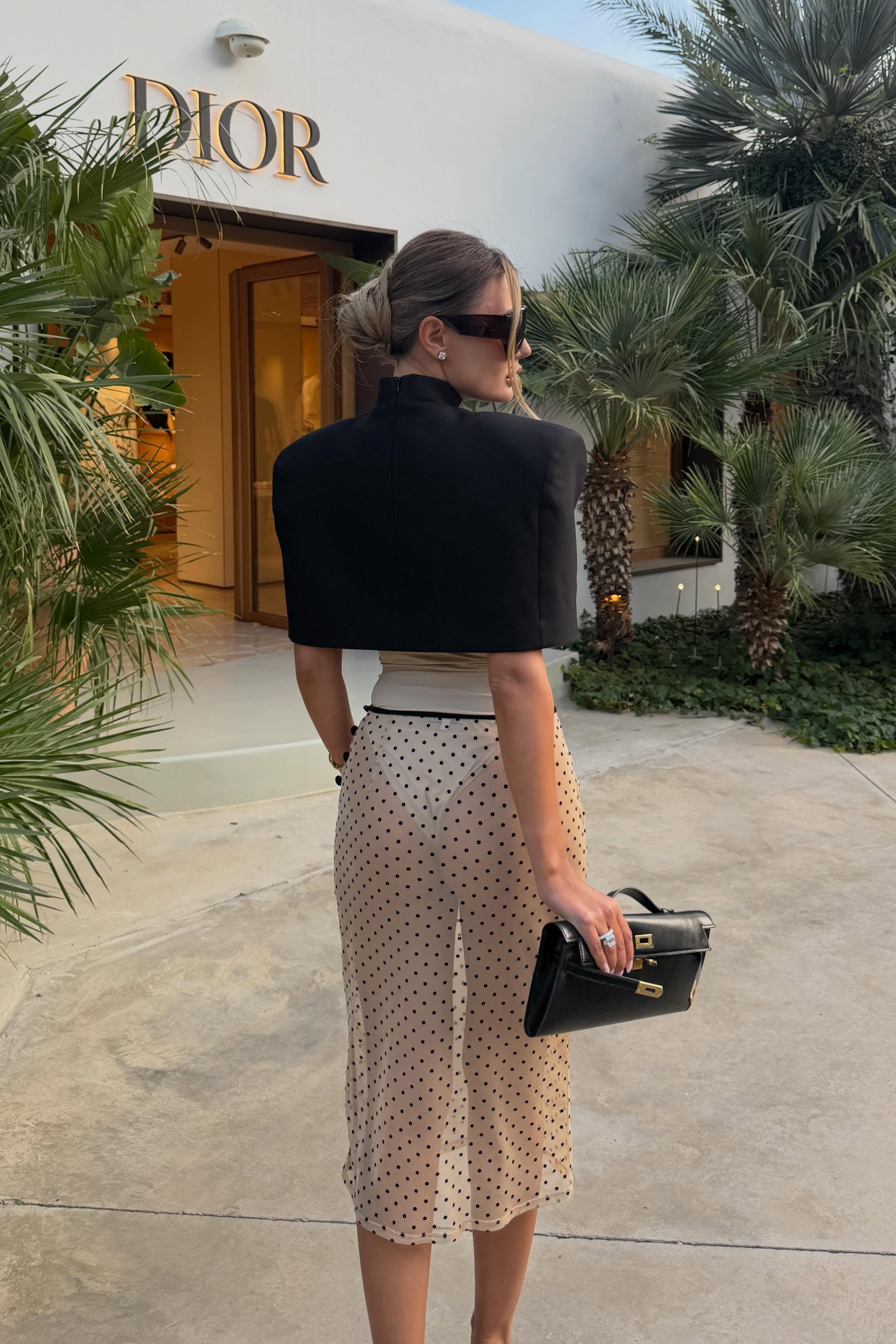Beige polka dot mesh skirt with soft drape and midi length, styled with black top