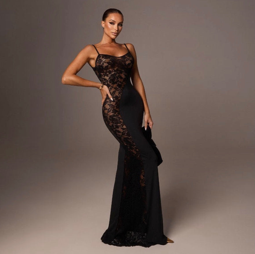 Woman wearing a black lace evening gown against a gray background