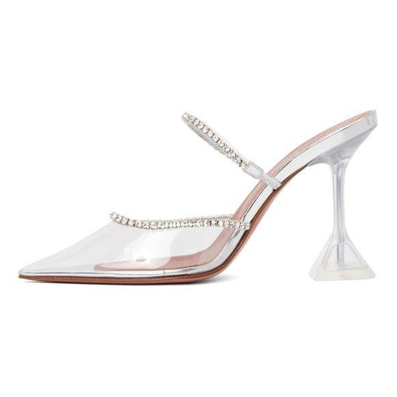 Clear high-heeled shoe with rhinestone embellishments on a white background