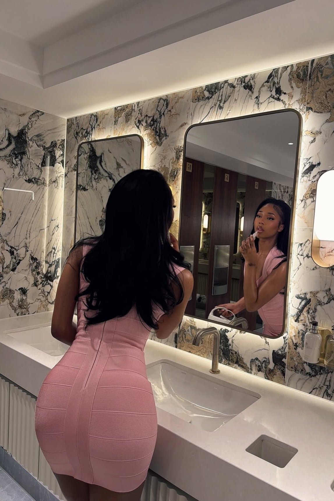 Pink bandage mini dress with hourglass silhouette, full-length shot