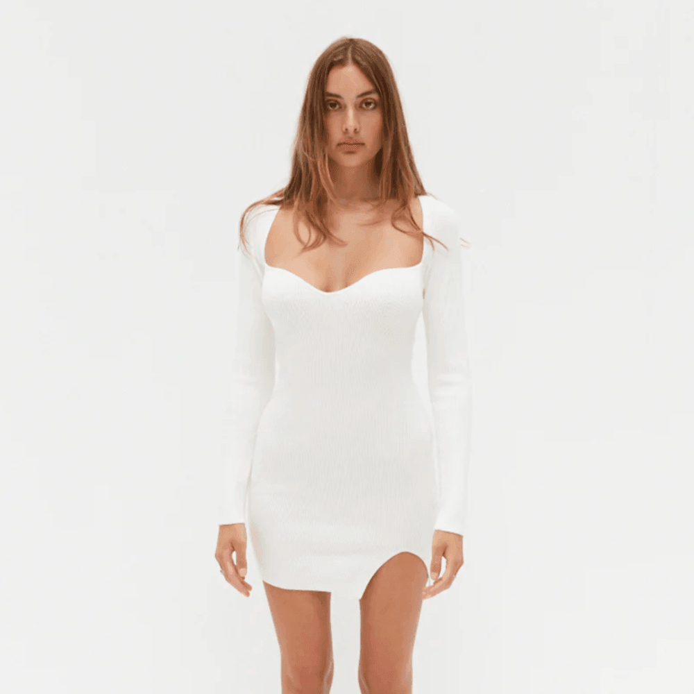 Woman wearing a white dress on a plain background