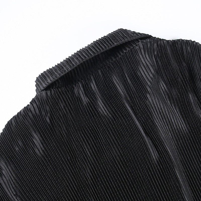 Close-up of black pleated fabric on a white background