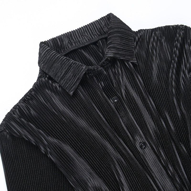 Black pleated shirt with a collar on a white background