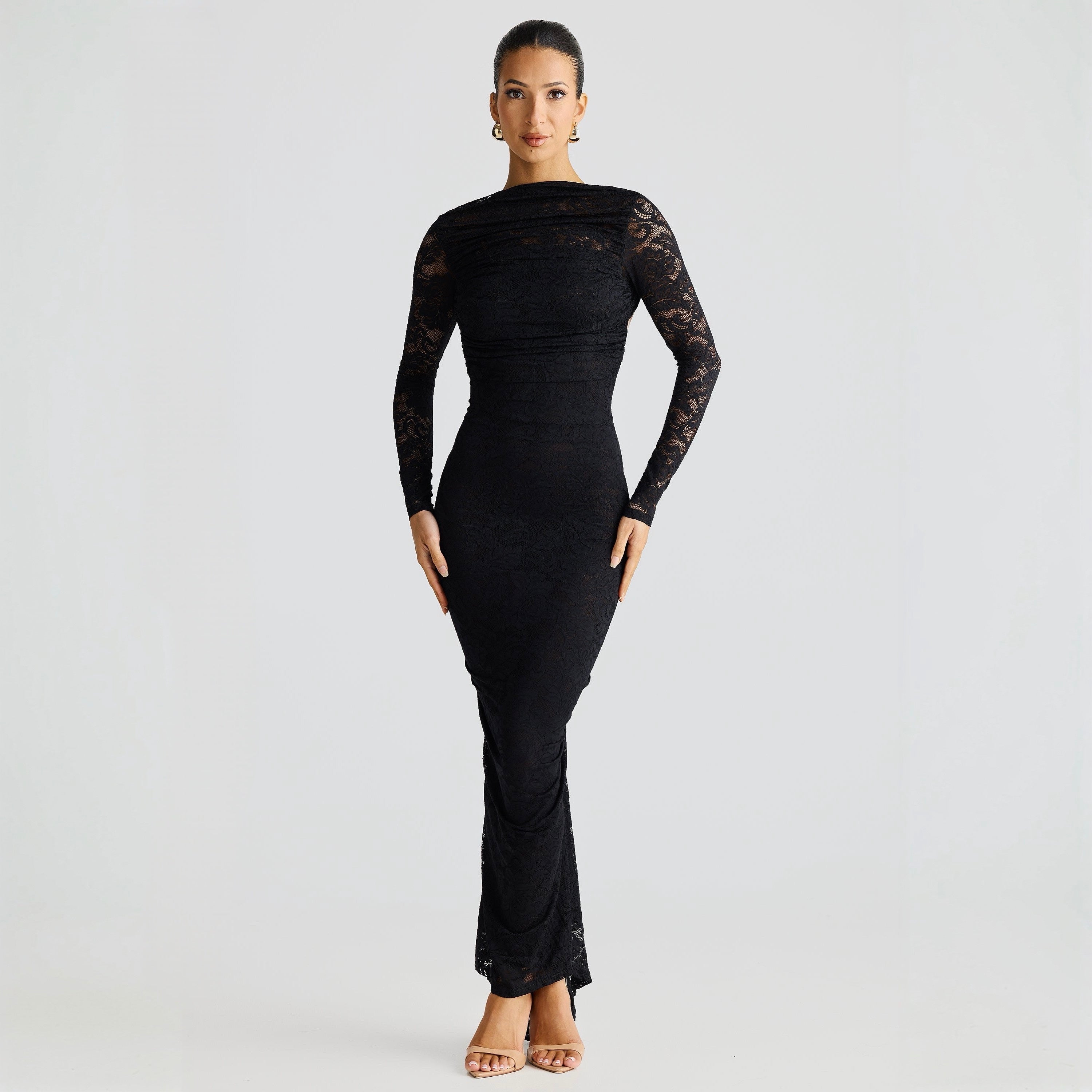 Woman wearing a black lace dress on a white background