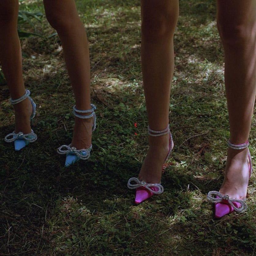 High-heeled shoes with decorative ribbons on a grassy ground.