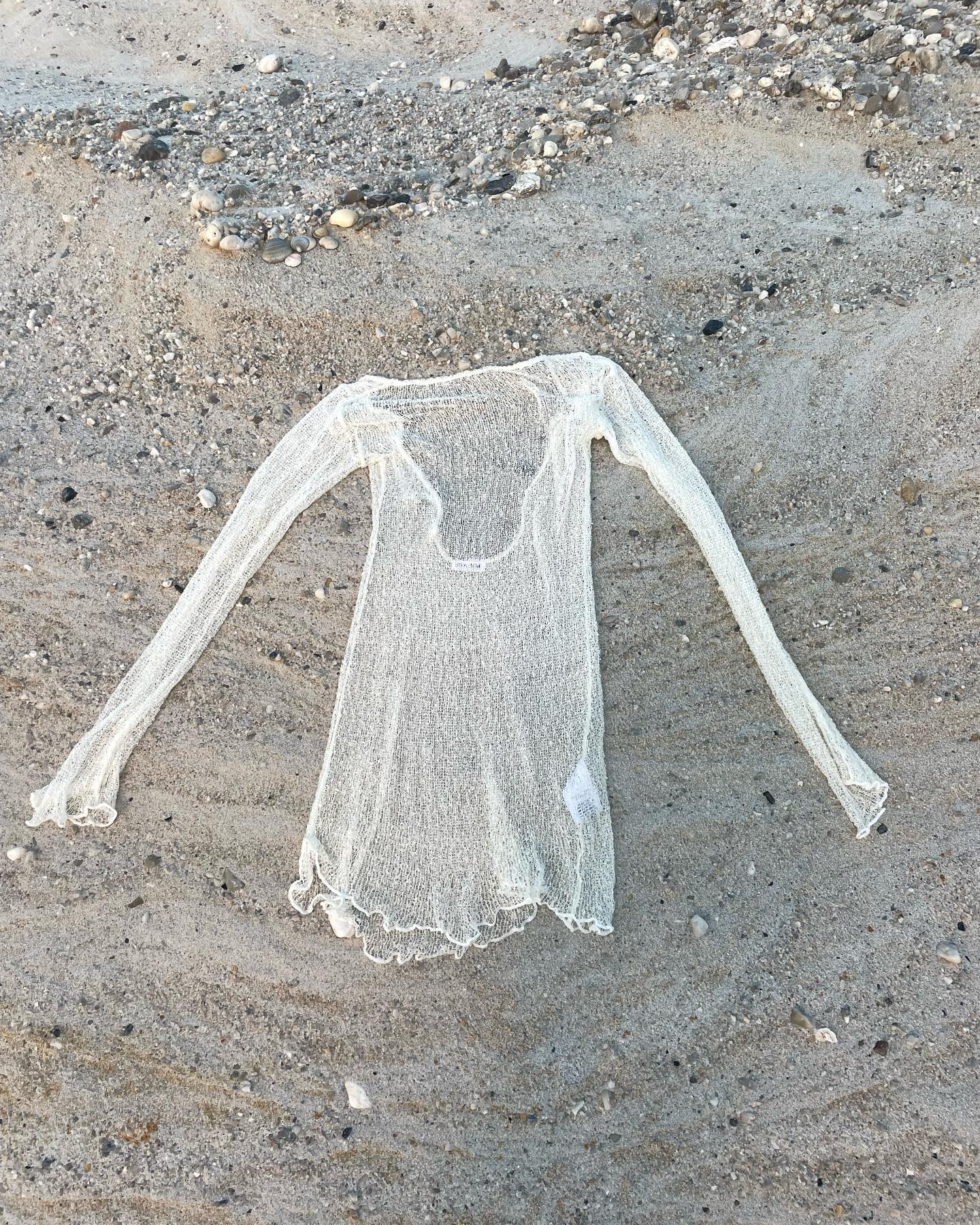 White open-back knit mini cover-up with flared cuffs, poolside editorial
