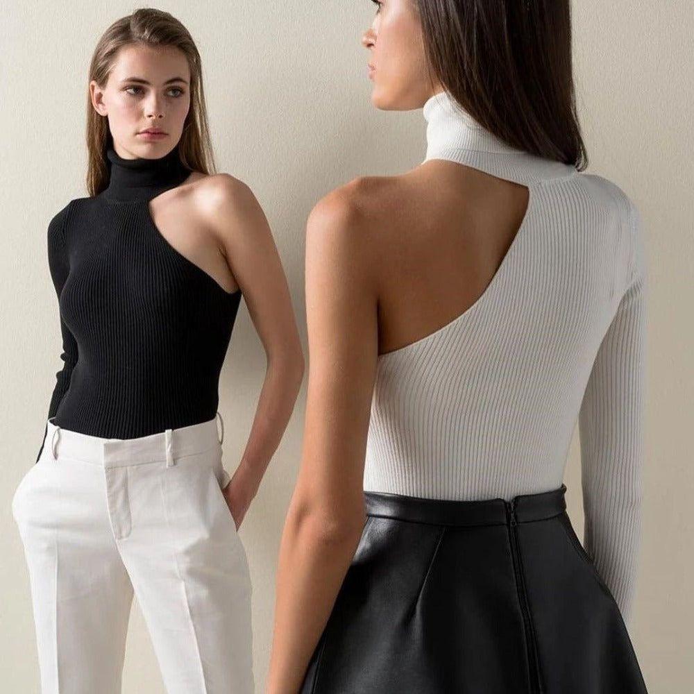 Two women wearing black and white sleeveless tops against a neutral background