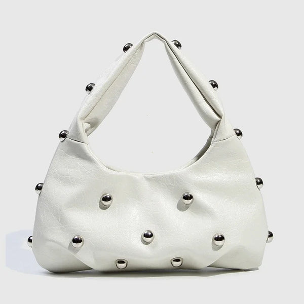 White studded handbag with a modern design.