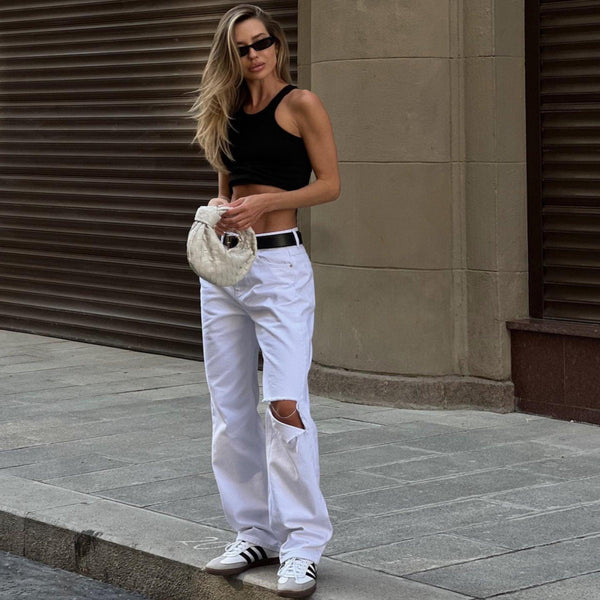Black crop top and white ripped jeans with casual sneakers, streetwear style