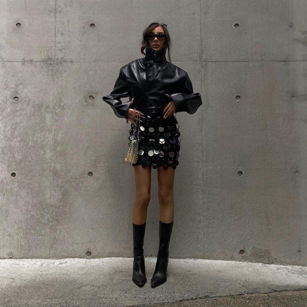black leather jacket with a sequin mini skirt and pointed knee-high boots, night-out style