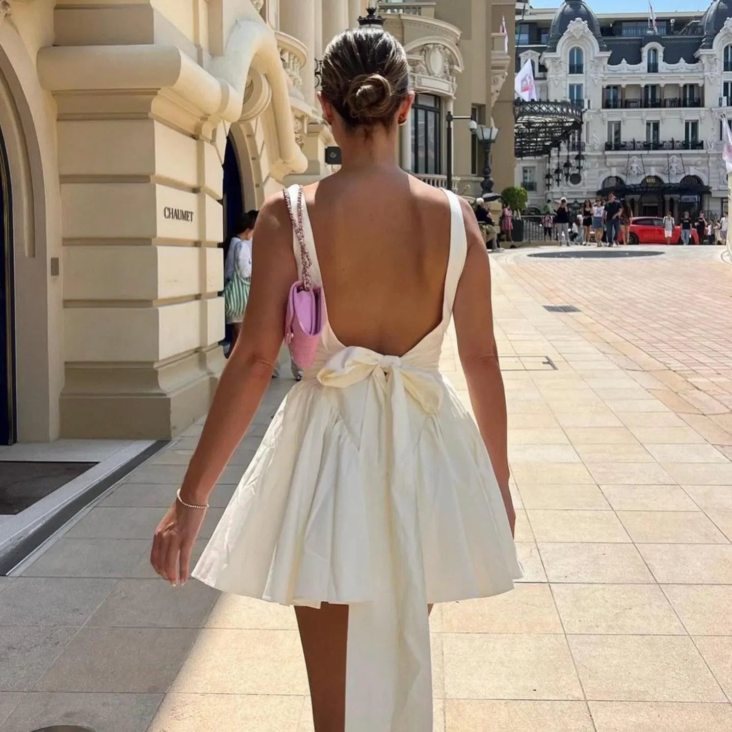Backless mini dress with bow detail, chic daytime attire