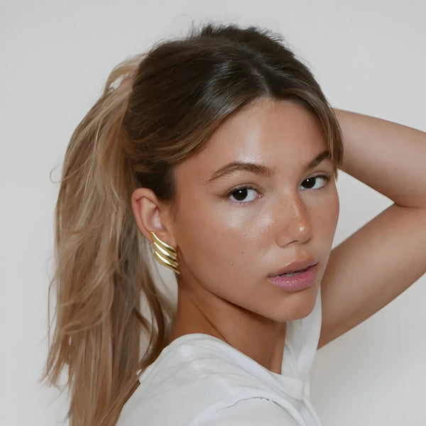Golden cuff earrings, minimalist accessory.
