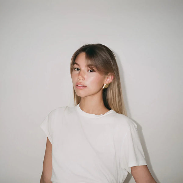 Plain white short-sleeve top with minimalistic style.