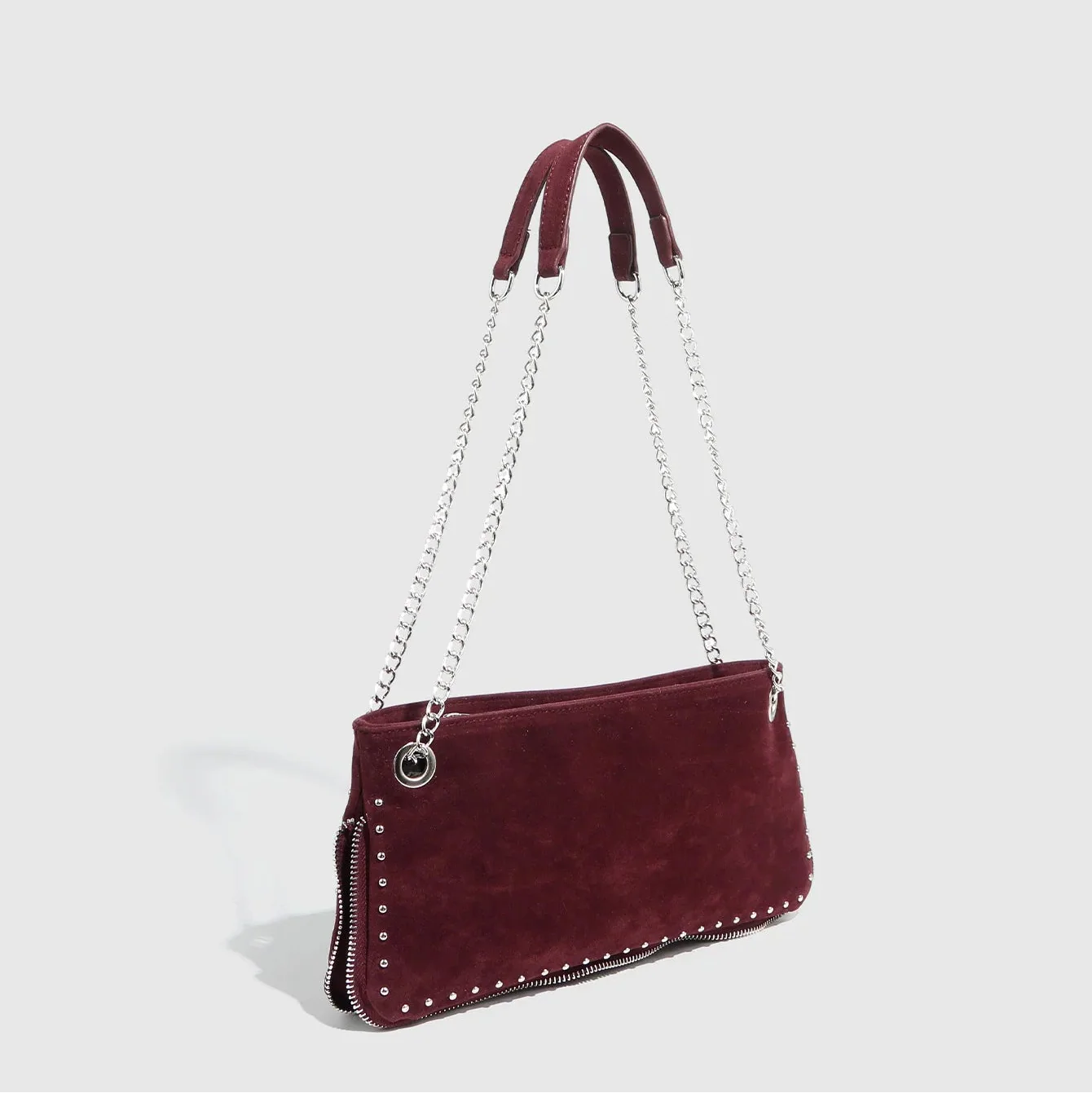 Burgundy suede handbag with silver chain straps and stud detailing, chic accessory for evening