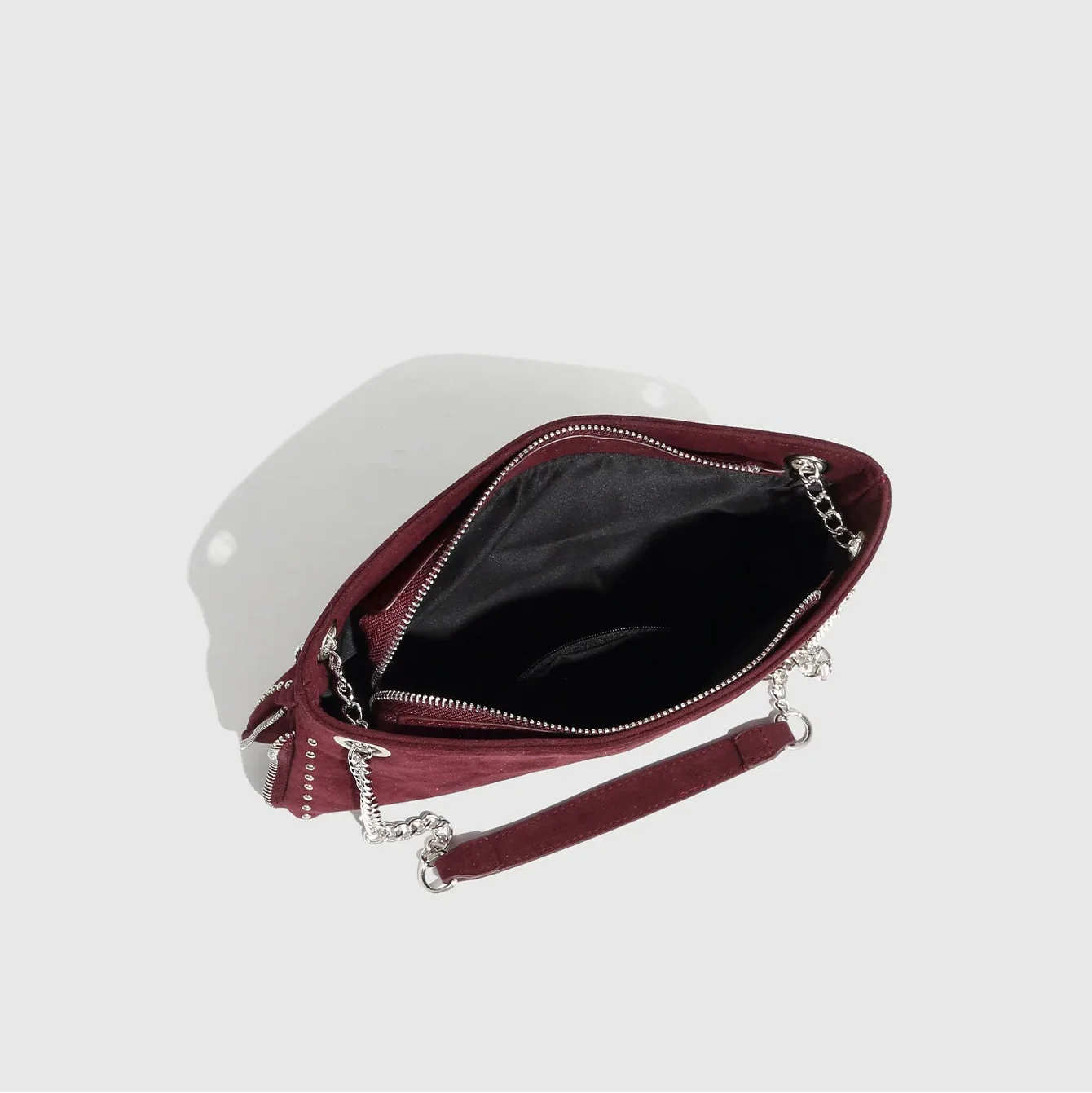 Burgundy suede bag with chain strap and zip closure, stylish accessory.