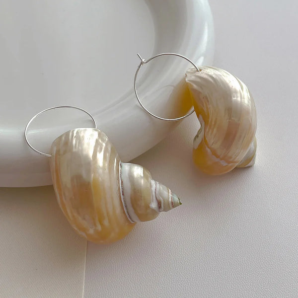 Shell hoop earrings with a pearly finish, beach-inspired accessory